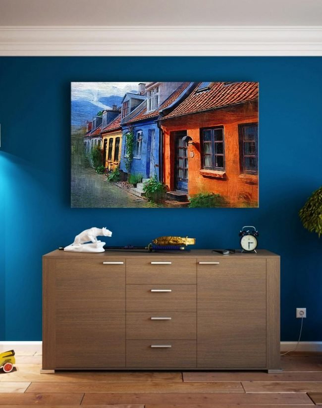 A modern living room featuring stylish bookshelves, a vibrant painting, and minimalistic decor.